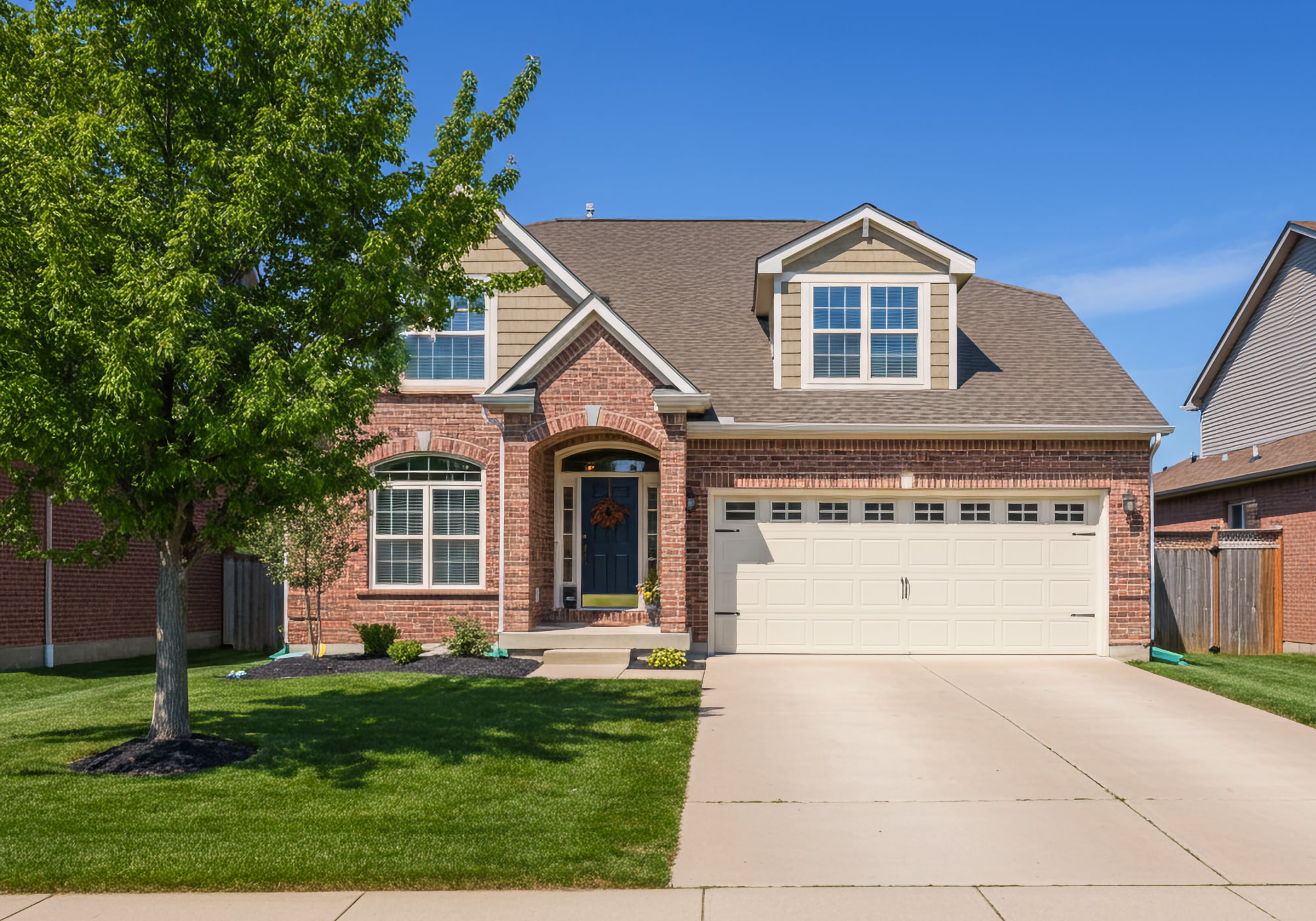 A 2010's two story brick home with two car attached garage in Brighton Michigan