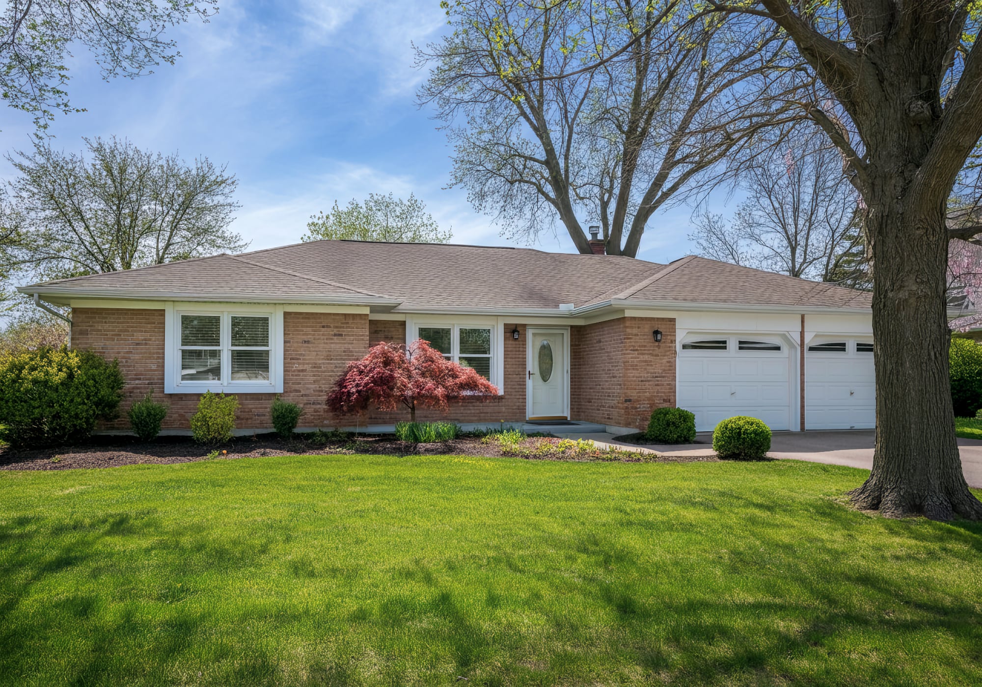 A 1960's brick ranch home with two car attached garage in Farmington Michigan