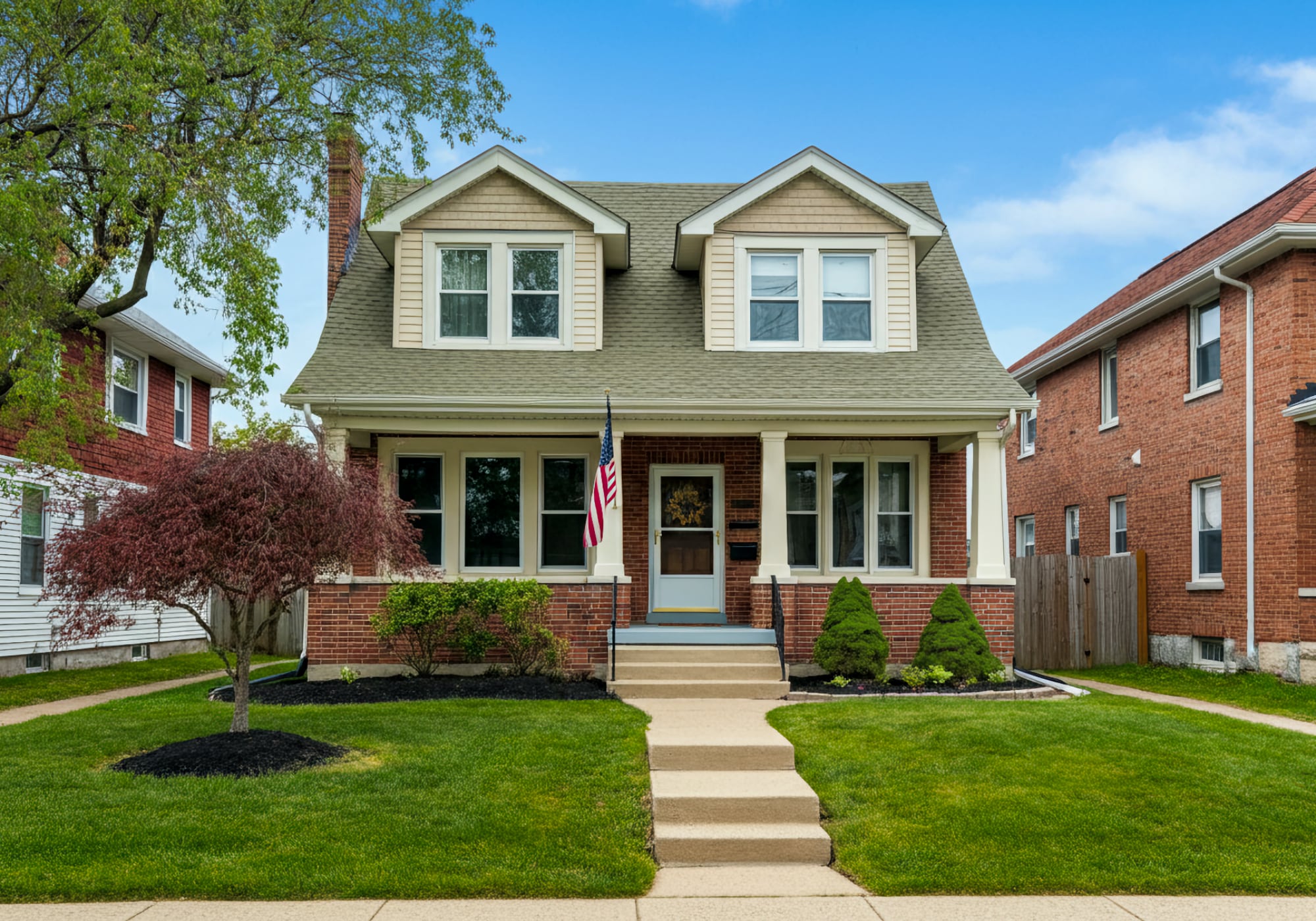 A 1930's bungalow home in Plymouth Michigan with an American flag