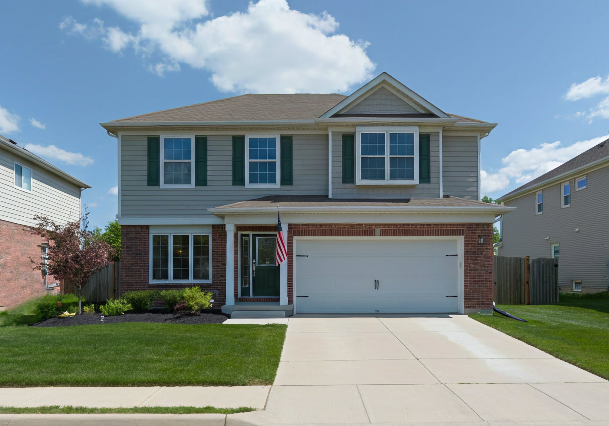 A 2000's two story brick home with an attached garage in South Lyon Michigan